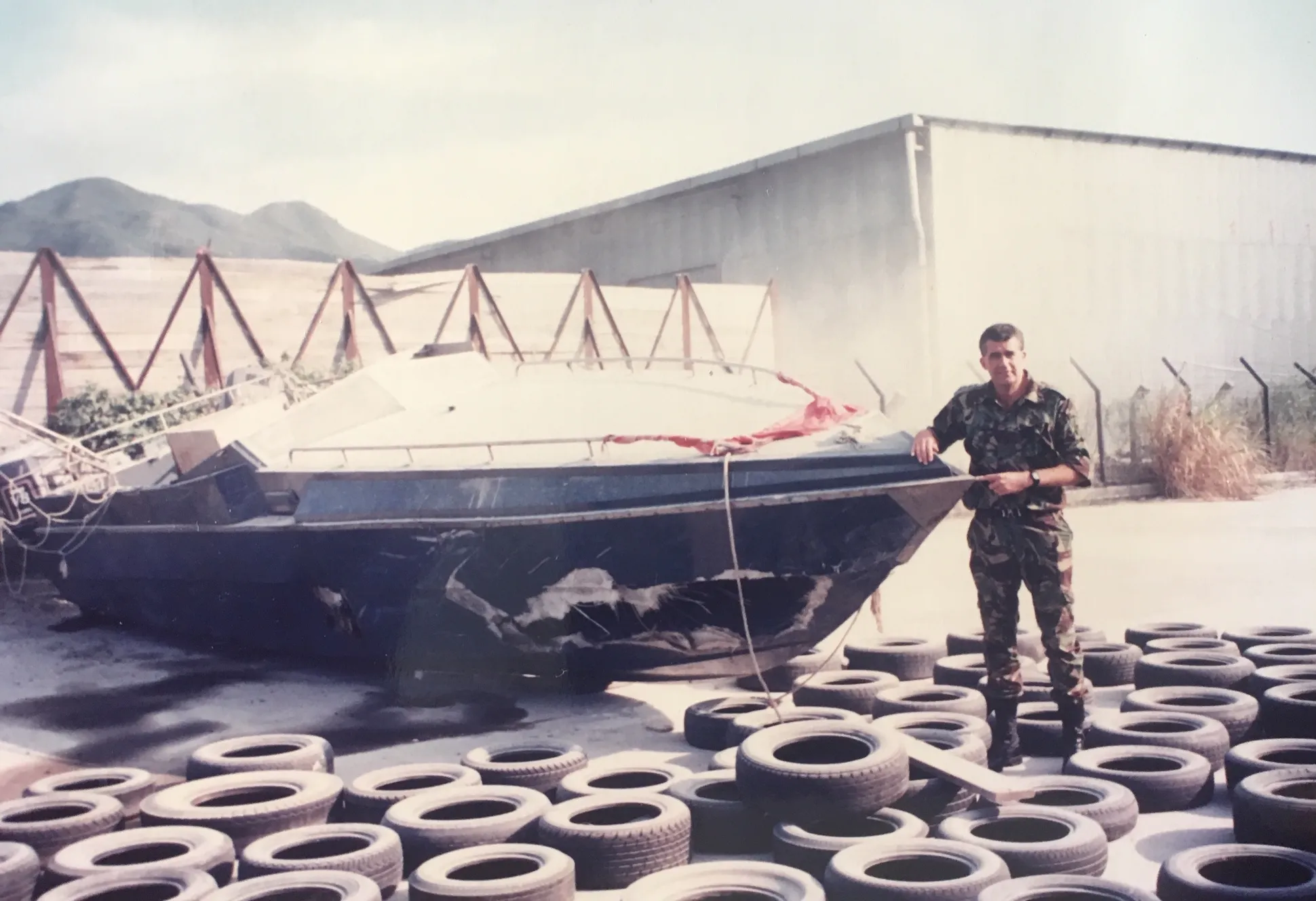 With a seized daai fei that ran aground during a chase the night before — pointing at the armour-plated bow used for ramming.